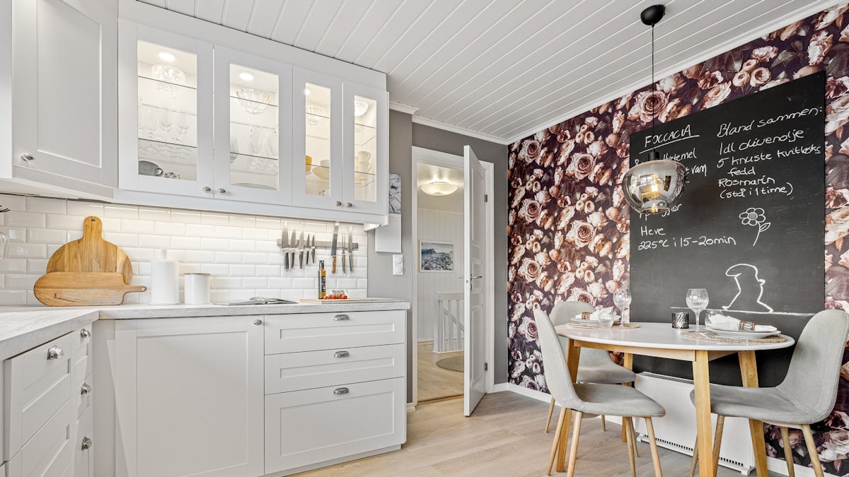 A kitchen with a chalkboard on the wall